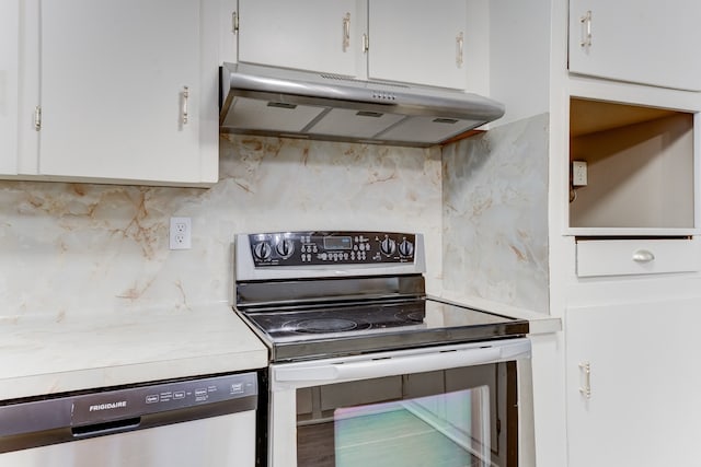 kitchen featuring white cabinets, stainless steel appliances, and backsplash