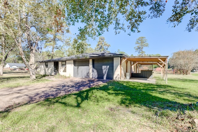 garage with a yard and a carport