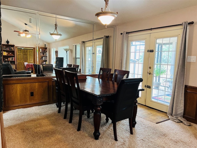 carpeted dining area featuring french doors, ceiling fan, and lofted ceiling