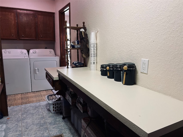 washroom featuring cabinets, washer and dryer, and light tile patterned floors