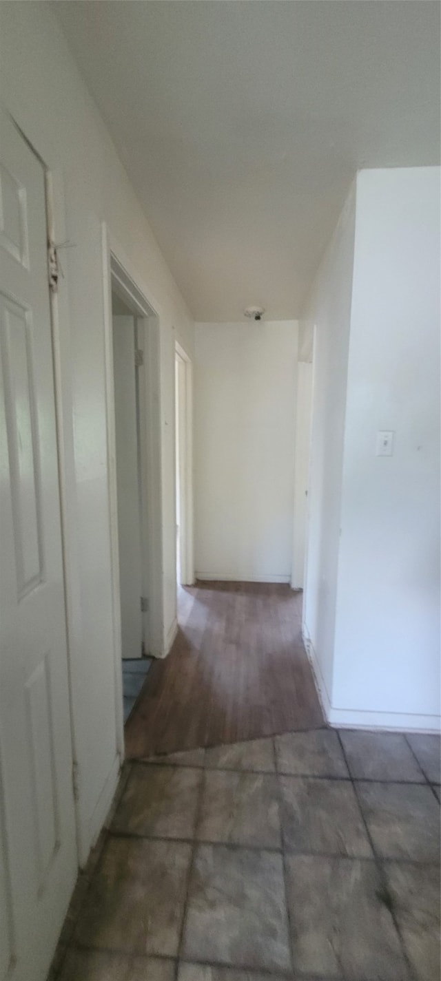 hallway with dark hardwood / wood-style flooring