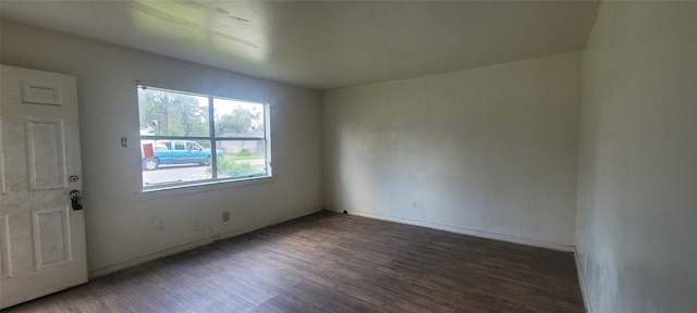 spare room with dark wood-type flooring