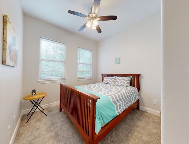 bedroom featuring light carpet and ceiling fan