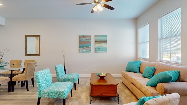 living room featuring light hardwood / wood-style floors and ceiling fan