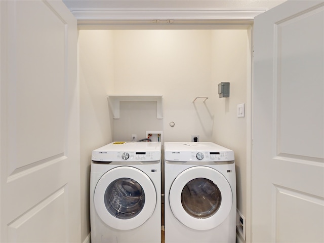 clothes washing area featuring separate washer and dryer