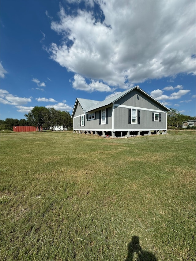 view of side of home with a lawn