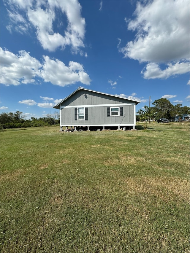 rear view of house featuring a lawn