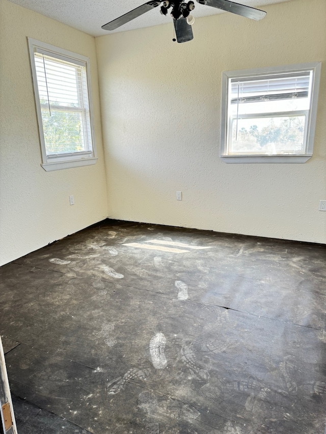 unfurnished room with a textured ceiling and ceiling fan