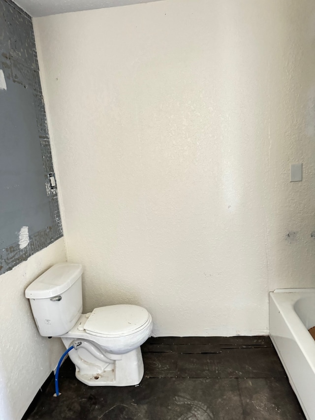 bathroom featuring toilet and a bathing tub