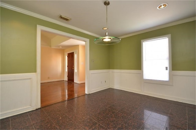 empty room featuring crown molding