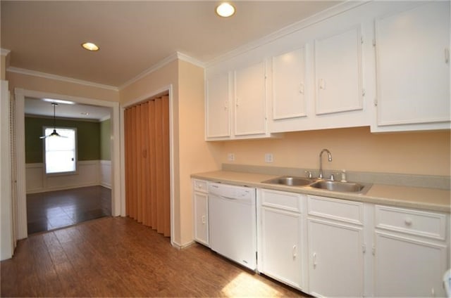 kitchen with dishwasher, wood-type flooring, sink, pendant lighting, and white cabinets