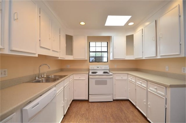 kitchen with sink, white cabinets, and white appliances