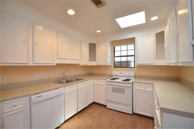 kitchen with sink, white cabinets, white appliances, and light hardwood / wood-style floors