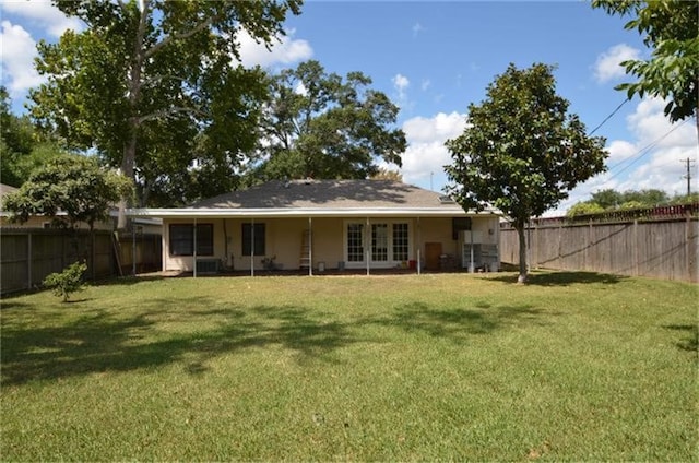 rear view of property featuring a yard