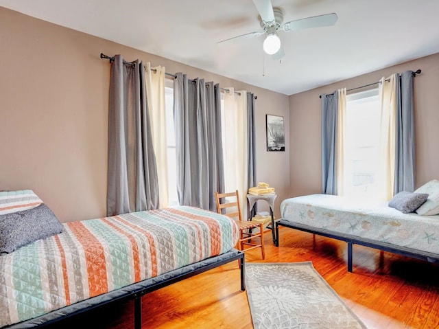 bedroom with hardwood / wood-style flooring and ceiling fan