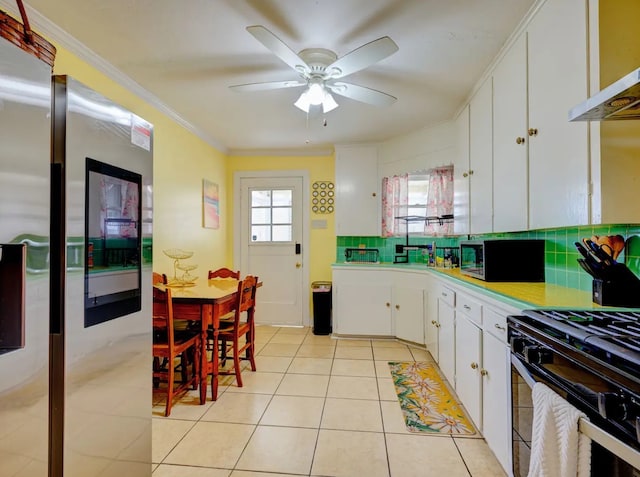 kitchen with exhaust hood, stainless steel appliances, backsplash, ornamental molding, and white cabinetry