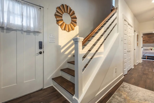 stairs featuring hardwood / wood-style floors