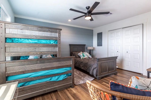 bedroom featuring dark wood-type flooring, electric panel, a closet, and ceiling fan