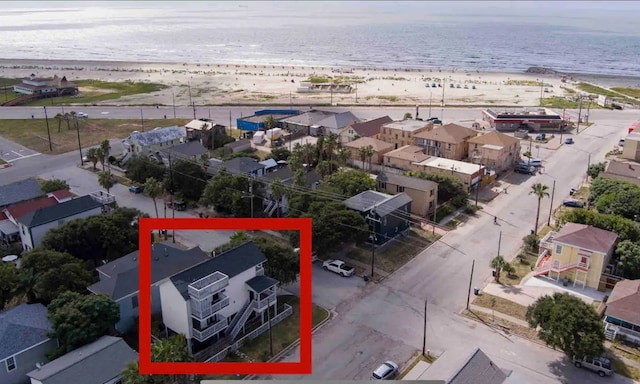 aerial view with a water view and a view of the beach