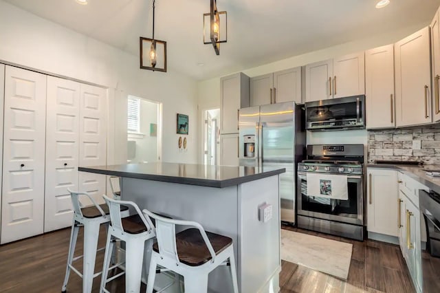 kitchen featuring a kitchen island, a kitchen bar, and stainless steel appliances