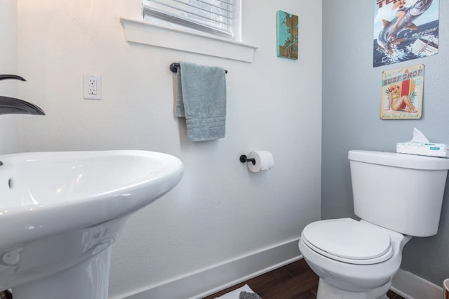 bathroom featuring toilet, hardwood / wood-style flooring, and sink