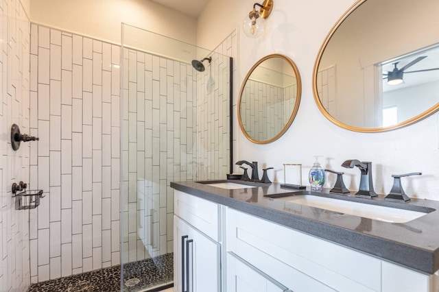 bathroom with vanity and tiled shower