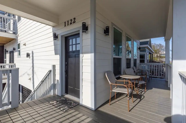 wooden terrace featuring covered porch