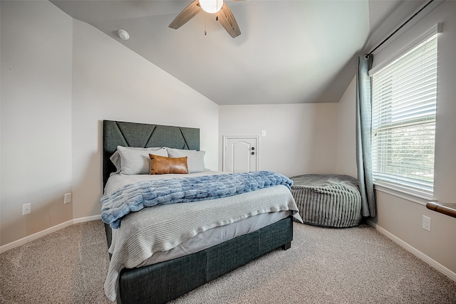 carpeted bedroom featuring ceiling fan and vaulted ceiling