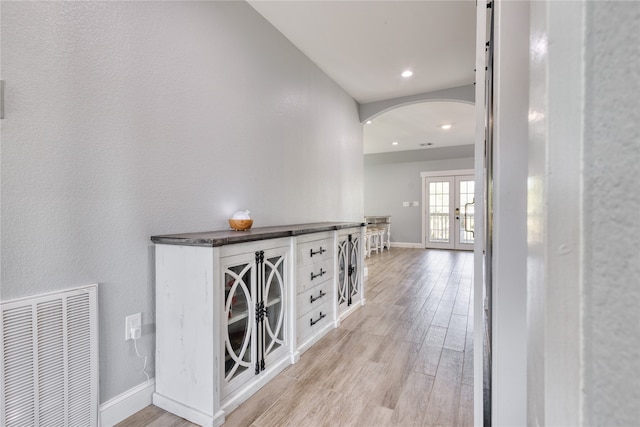 corridor featuring light hardwood / wood-style flooring and french doors