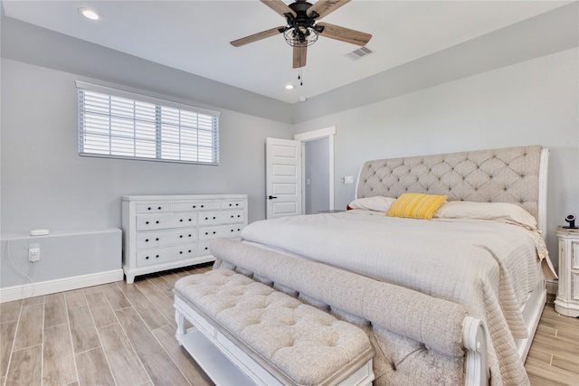 bedroom with light hardwood / wood-style flooring and ceiling fan