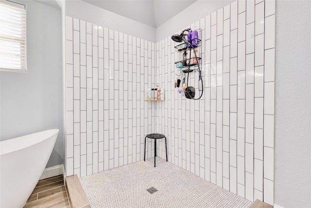 full bath featuring a soaking tub and tiled shower