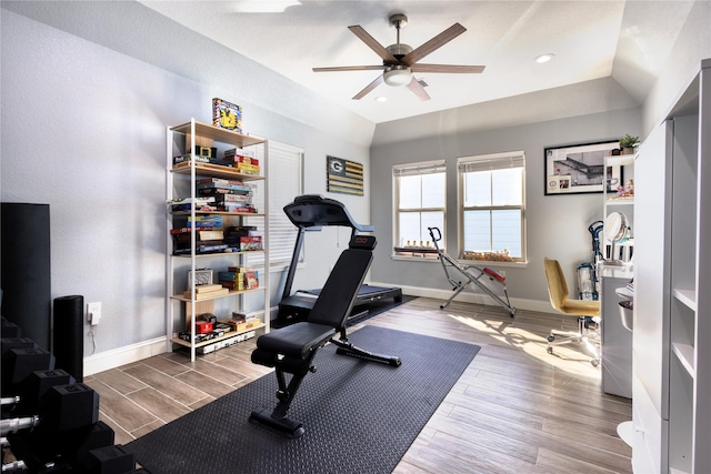 workout room with a ceiling fan, baseboards, recessed lighting, wood finished floors, and vaulted ceiling