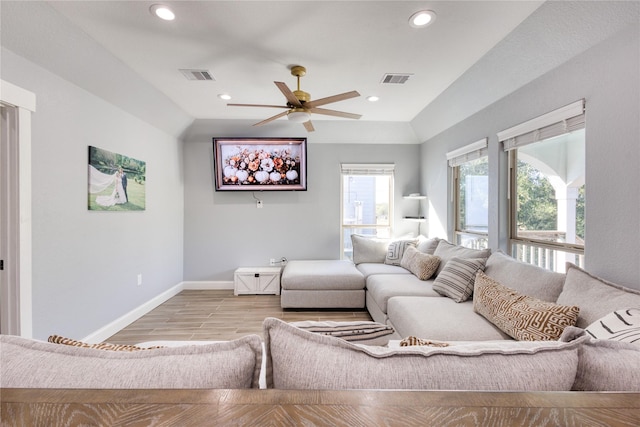 living area with visible vents, a ceiling fan, baseboards, and lofted ceiling