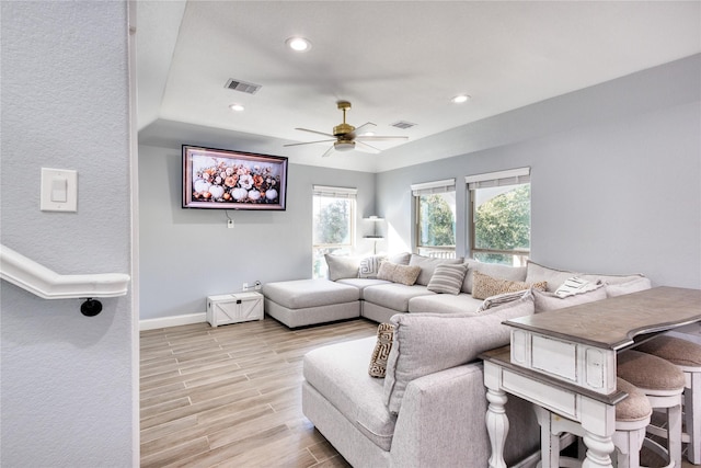 living room featuring ceiling fan, light wood-style flooring, recessed lighting, baseboards, and visible vents