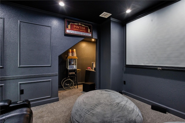 carpeted cinema featuring recessed lighting, ornamental molding, a textured wall, and visible vents