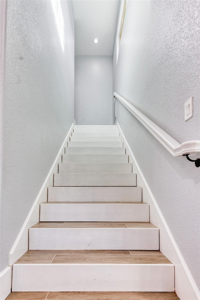 stairs featuring a textured wall