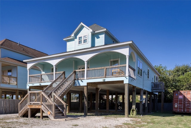 back of property featuring covered porch, stairs, and a carport
