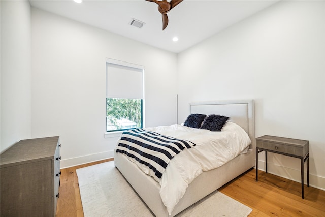 bedroom with light hardwood / wood-style flooring and ceiling fan