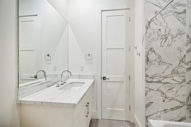 bathroom featuring vanity and tiled shower / bath