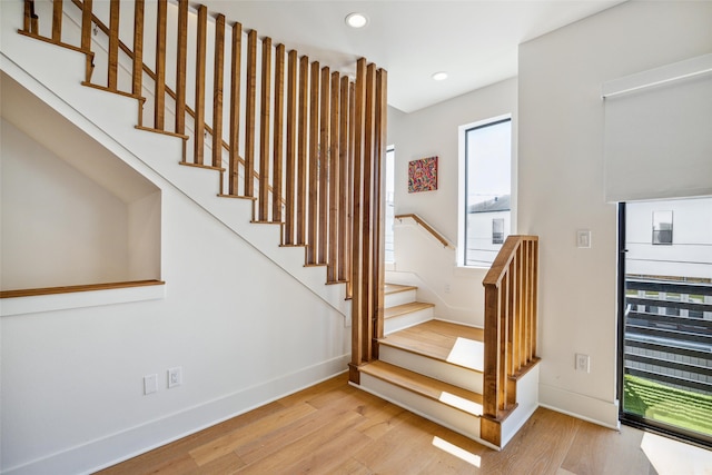 staircase with hardwood / wood-style floors