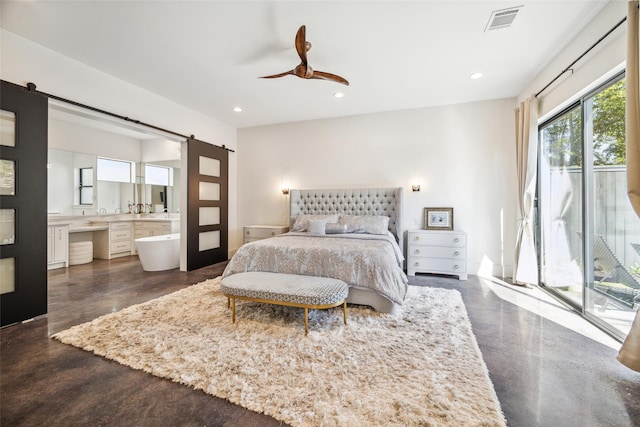 bedroom featuring connected bathroom, a barn door, access to outside, and ceiling fan