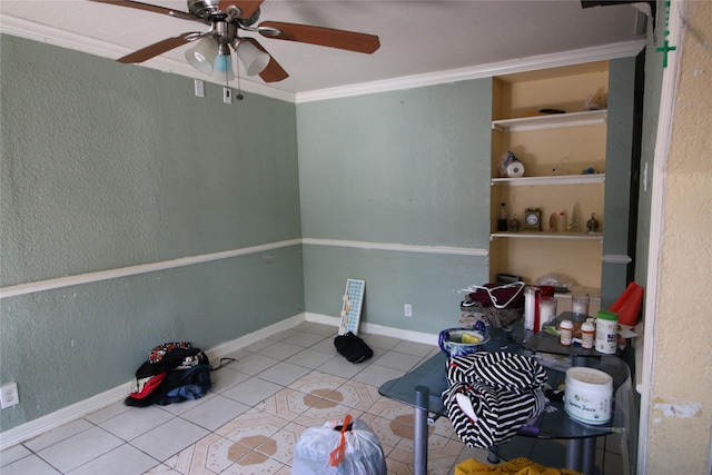 interior space with ornamental molding, baseboards, a ceiling fan, and tile patterned flooring