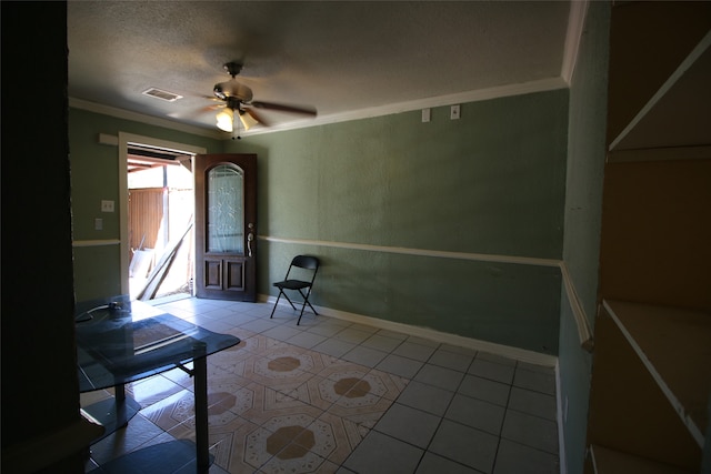 tiled entryway with ceiling fan, ornamental molding, and a textured ceiling