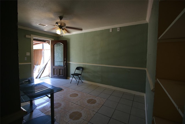 tiled entryway featuring baseboards, a ceiling fan, crown molding, and visible vents