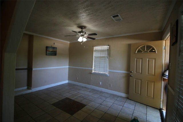 foyer featuring a ceiling fan, a textured ceiling, baseboards, tile patterned flooring, and visible vents