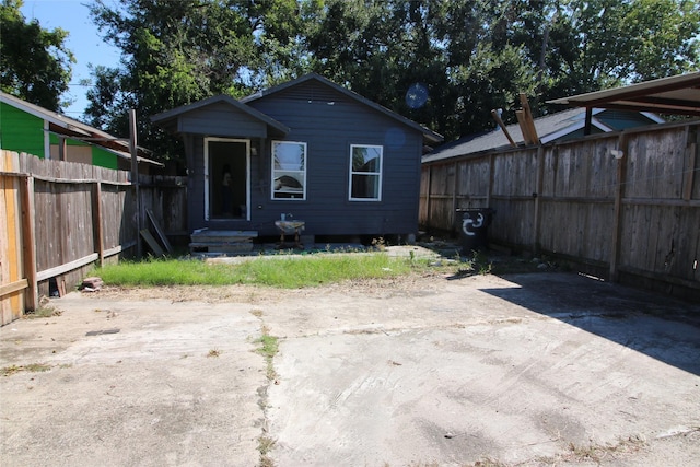 rear view of property featuring fence