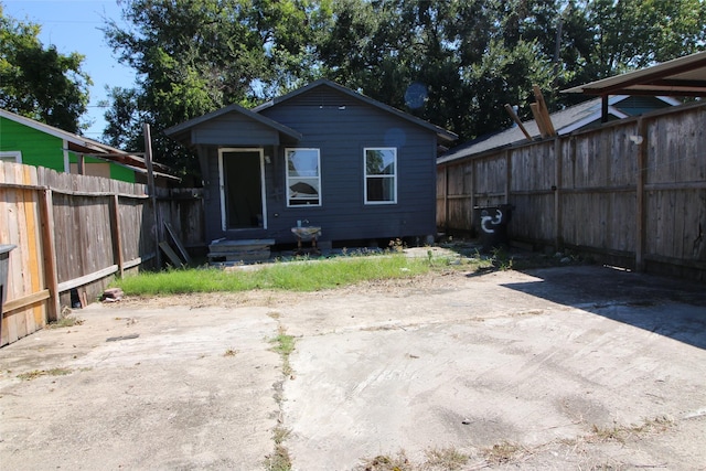 rear view of house with fence