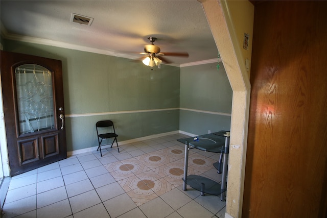 interior space with crown molding, a textured ceiling, light tile patterned floors, and ceiling fan