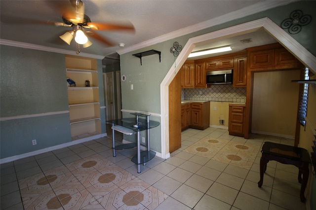 kitchen with ornamental molding, light tile patterned flooring, tasteful backsplash, and ceiling fan