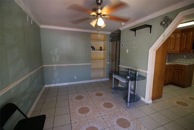 unfurnished living room with a ceiling fan, baseboards, light tile patterned floors, and crown molding